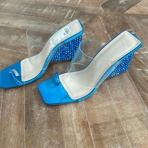 Betsy Johnson teal rhinestones, clear plastic around foot